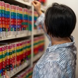 Person putting property files on file shelf