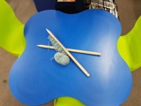 Knitting needles and yarn on a bright blue table