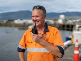 Man smiling using radio